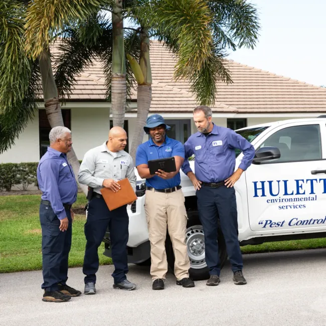 Hulett technicians near company truck laughing