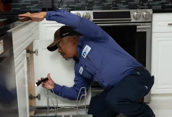 tech-checking-under-sink