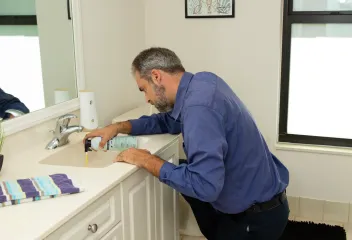 tech-checking-bathroom